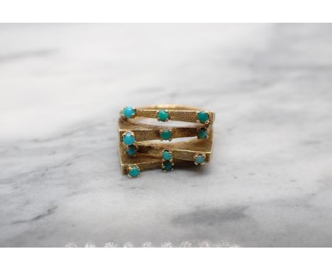 A contemporary Turquoise Ring claw-set twelve small cabochons to the four textured bands in 14ct gold, Israel marks, ring siz