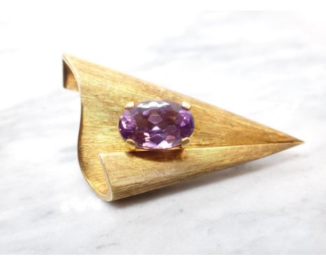 A contemporary Amethyst Brooch claw-set single oval-cut stone, unmarked untested, 6cms long, approx 13.90gms 