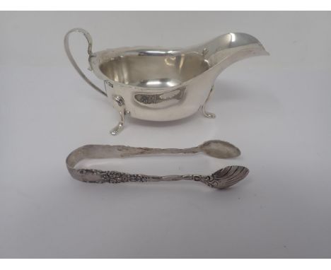 A George V silver Sauce Boat, Sheffield 1933, and a pair of silver Sugar Tongs, Birmingham 1900 