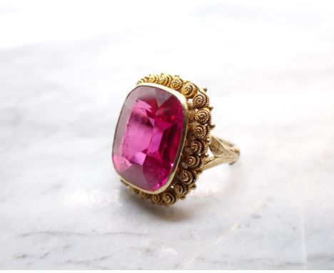 A synthetic Ruby Ring millegrain-set large cushion-cut stone in cannetille frame, stamped 585, ring size G 1/2 