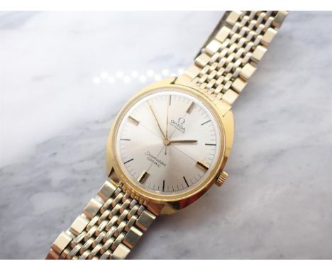A gentleman's Omega Automatic Seamaster Cosmic Wristwatch the silvered dial with hourly baton markers and sweep seconds hand 