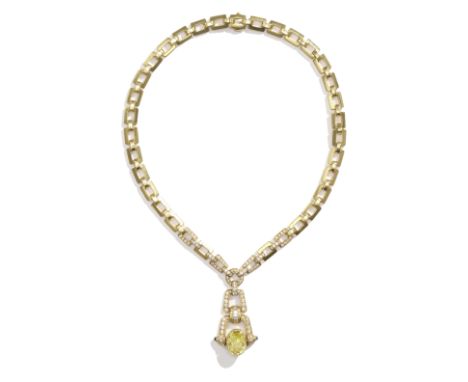 CARTIER: YELLOW SAPPHIRE, SAPPHIRE AND DIAMOND NECKLACEThe oval-cut yellow sapphire between sapphire cabochon finials, pavé-s