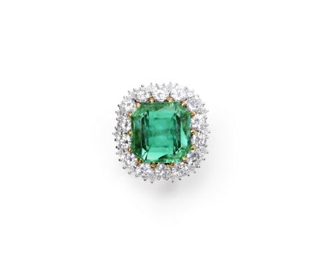 EMERALD AND DIAMOND CLUSTER RINGThe octagonal-cut emerald, weighing 13.25 carats, within a surround of brilliant-cut diamonds