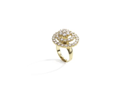 NORMAN TEUFEL: DIAMOND 'SWINGER' RING, CIRCA 1975Of kinetic design, the brilliant-cut diamond cluster spinning within two tie