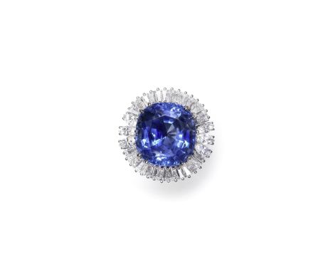 SAPPHIRE AND DIAMOND CLUSTER RINGThe cushion-shaped sapphire, weighing 26.51 carats, within a surround of tapered baguette an
