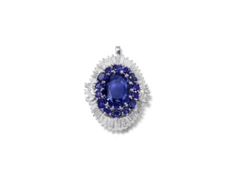 SAPPHIRE AND DIAMOND PENDANTThe oval-cut sapphire, weighing 18.13 carats, within a surround of circular, oval-cut sapphires, 