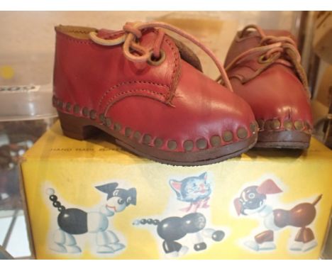 Boxed Pelham cat puppet and a pair of childs clogs