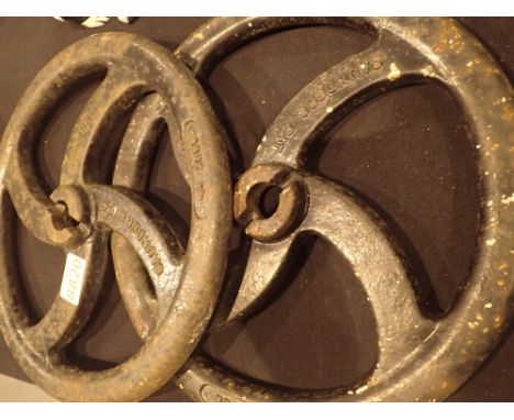 Two antique cast iron traction engine control wheels