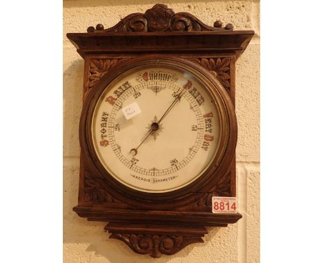 Antique Arts and Crafts aneroid barometer with carved oak surround