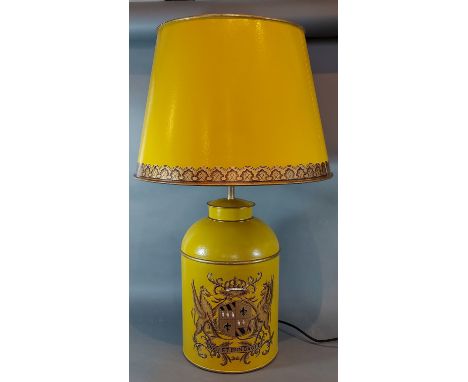 A Toleware table lamp decorated with an Armorial crest upon a mustard ground with Toleware shade, 70cms 