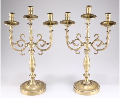A LARGE PAIR OF VICTORIAN HEAVY BRASS THREE-LIGHT CANDELABRA, with scroll-form branches. (2) 42cm high
