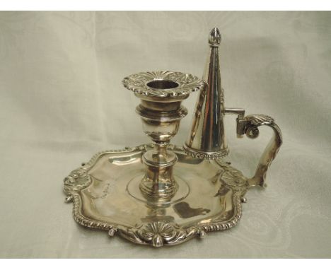 A Georgian silver chamber stick and snuffer having gadrooned and scallop shell decoration to base, column candle holder with 