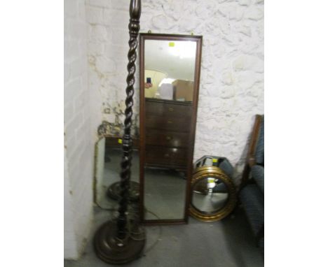 A group of wall mirrors and an oak barley twist standard lamp