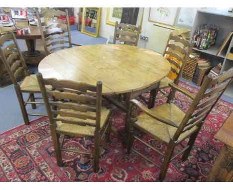 A set of six country ladder back chairs, including two carvers, with rattan seats and a 19th century oak gate leg dining tabl