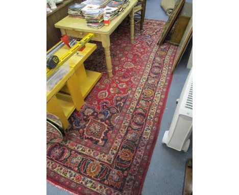 A Persian design carpet with a central medallion on a red ground, 148 x 113