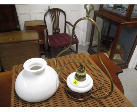 A ceiling hanging oil light with brass mounts
