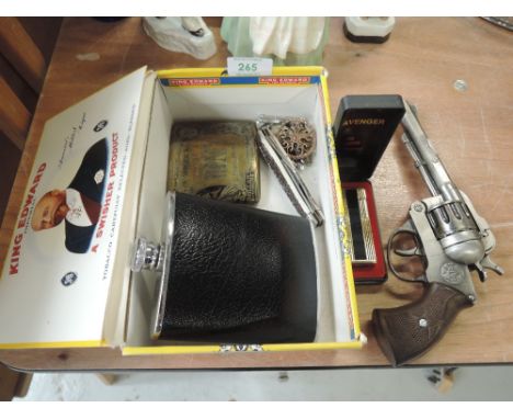A selection of curios including cigarette holder and Avenger gas lighter