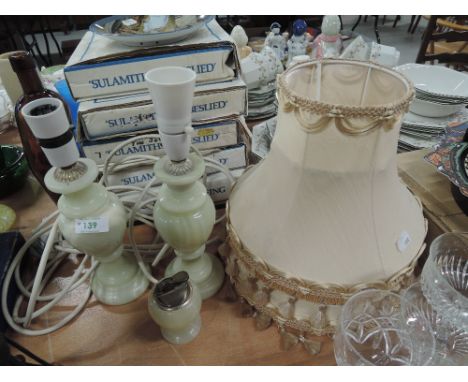 A pair of stone cut lamps and similar lighter