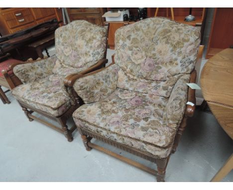 A pair of  modern Ercol mid stain upholstered armchairs