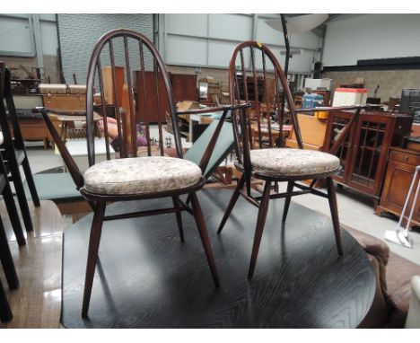 Two dark stained Ercol style spindle back kitchen carver chairs