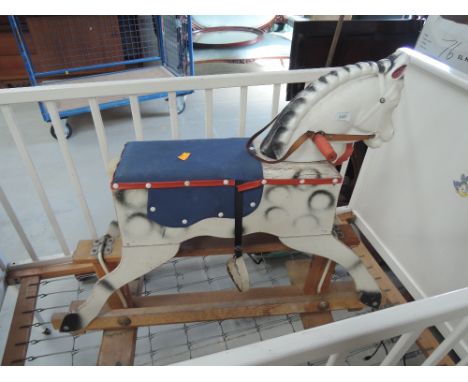 A vintage rocking horse having wood frame , body and plastic head