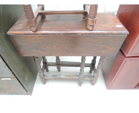 An oak gate leg table with twist legs