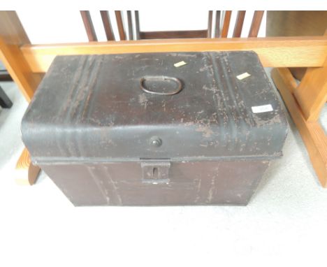 A vintage tin trunk of small proportions