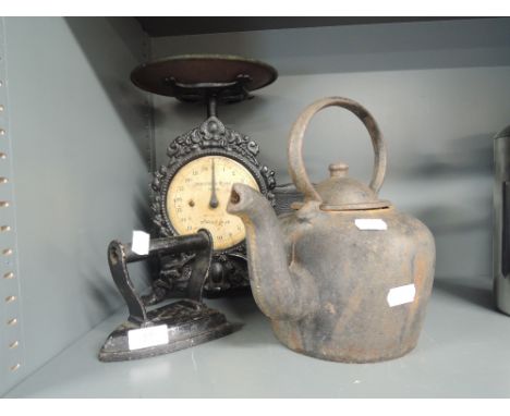 A selection of hardware including heavy cast stove kettle and elaborate Household scale