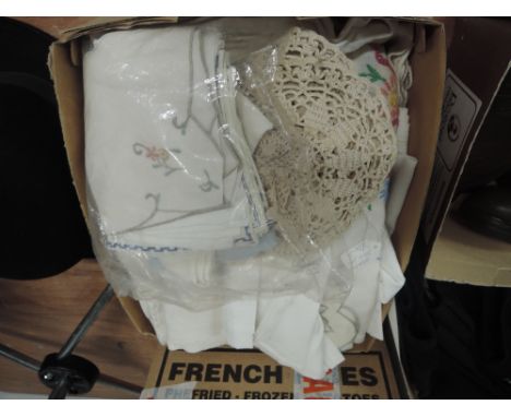 A selection of vintage table linen, some with intricate techniques used and floral embroidery. No arm covers