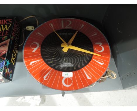 An atomic design electric clock with light up psychedelic revolving centre The Flying Bird standard electric clock in full wo
