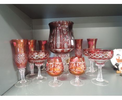 A selection of cranberry glass wares including table lamp and wine glasses