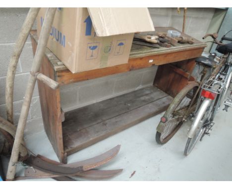 A vintage wooden gardeners potting bench with sloped top