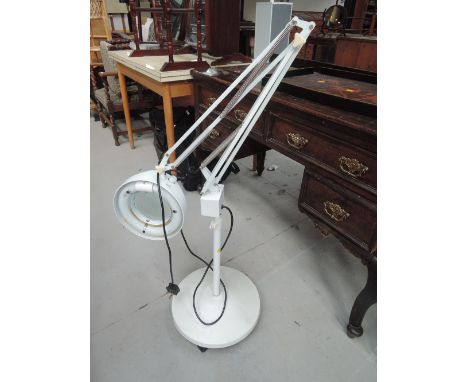 A vintage angle poise magnifying lamp