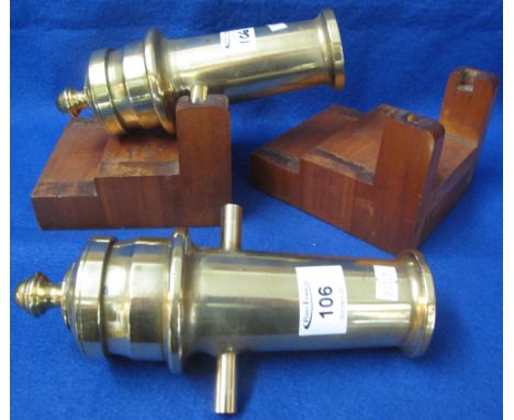 Pair of brass ship's cannon ornaments on stepped wooden bases. (2)