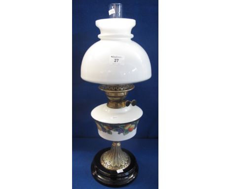 Early 20th Century double burner oil lamp with printed ceramic reservoir, decorated with stylised fruit on a fluted brass col