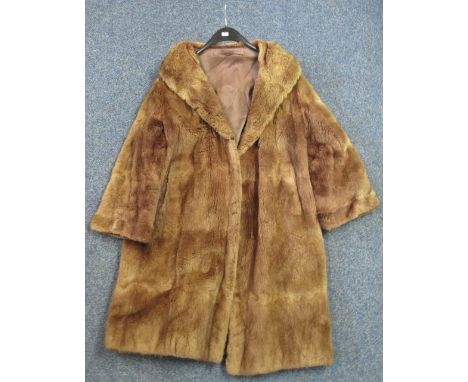A three-quarter length vintage light brown fur coat, probably rabbit fur.  No label.