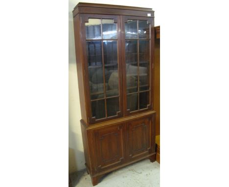 Early 20th Century mahogany glazed bookcase on bracket feet.