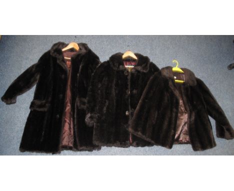 Two vintage dark brown faux fur button up coats and one dark brown faux fur jacket.  The jacket is made by Lister Manquilla. 