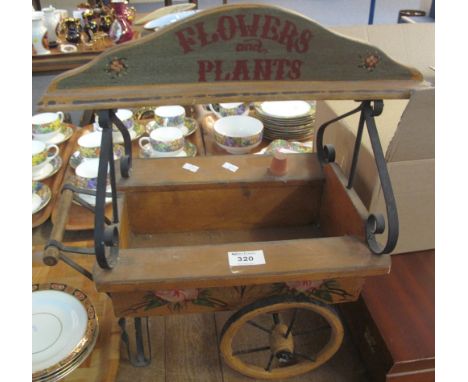 Novelty wooden and metal planter in the form of a miniature cart, labelled: 'Flowers and plants'.