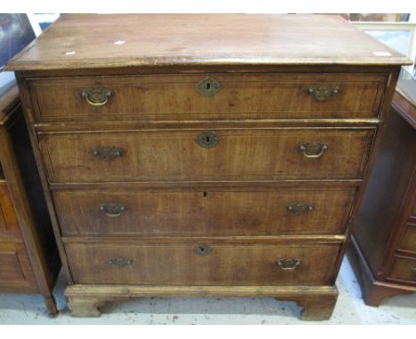 18th Century pine and walnut veneered straight front chest of four long drawers on bracket feet.  
