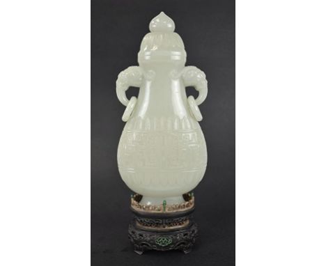 Chinese Carved White Jade Covered Vase Chinese carved celadon jade covered vase with two  hand with ring. and a match wood st