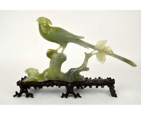 Chinese Carved Light Green Jade Birds Chinese carved jade bird resting on a rock, with  carved wood stand. Figure: 6 1/2" x 1