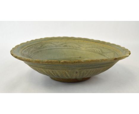 Chinese Celadon Glazed Pottery Bowl Chinese ceramic bowl covered in a celadon glaze  with incised design. 3/4" chip to edge. 