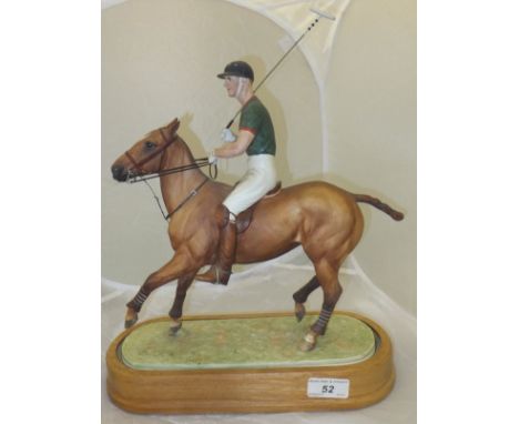 A Royal Worcester figure group "HRH The Duke of Edinburgh", depicting the Duke of Edinburgh playing polo, raised on a wooden 