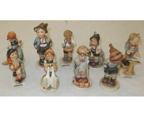 A collection of nine Goebel Hummel figures to include : "Brother", "Little Drummer", "Merry Wanderer", "Little Sweeper", "Doc