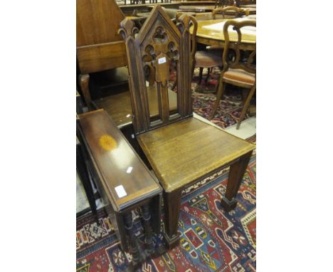 A Victorian oak panel seated hall chair in the Gothic Revival taste and a late 19th Century Victorian mahogany and inlaid Sut