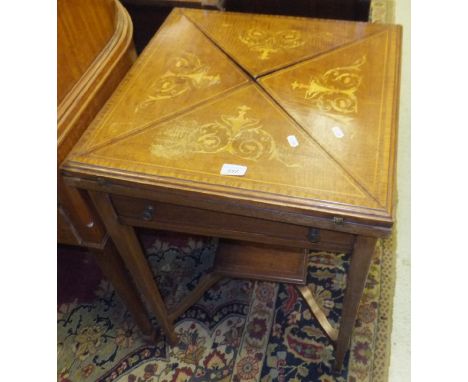 A circa 1900 mahogany and inlaid envelope card table with single drawer on square tapering legs, united by an undertier