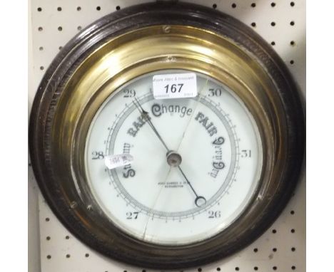 A brass cased ships barometer by John Barker & Co. Ltd. of Kensington, and a Victorian brass skeleton clock (for restoration)