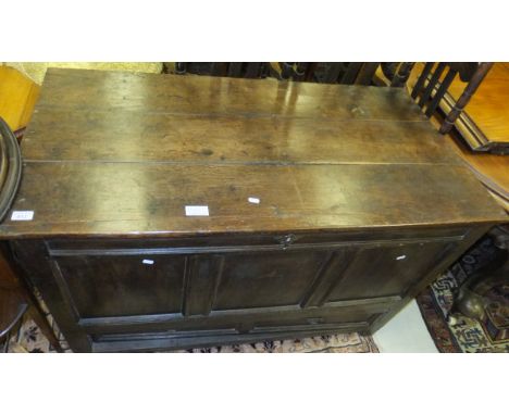 An 18th Century oak mule chest, the plain top over a three plain panel front with single drawer (as two drawers) on stile sup