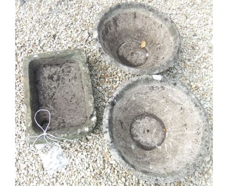 A natural stone rectangular shallow sink / trough, together with a pair of 20th Century composition garden jardiniers of coni